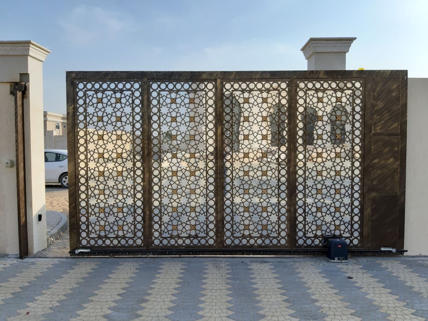 A sliding gate with its motor and rack visible